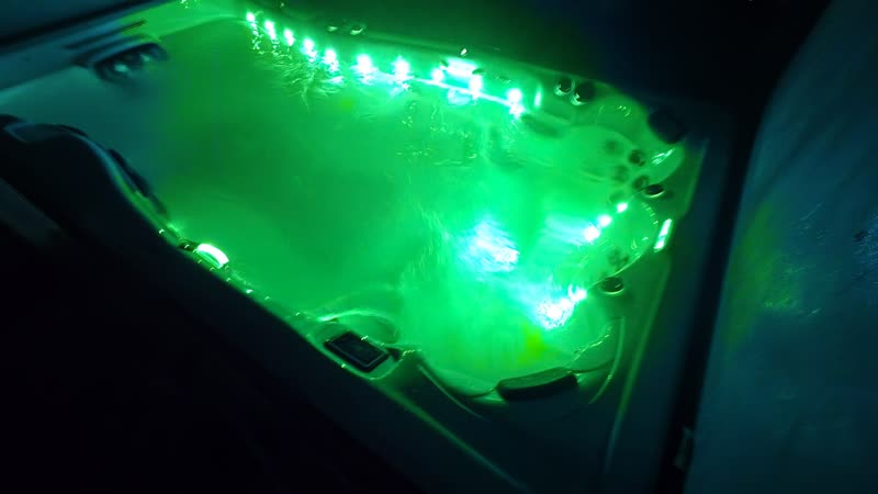 Swim spa glowing green at night